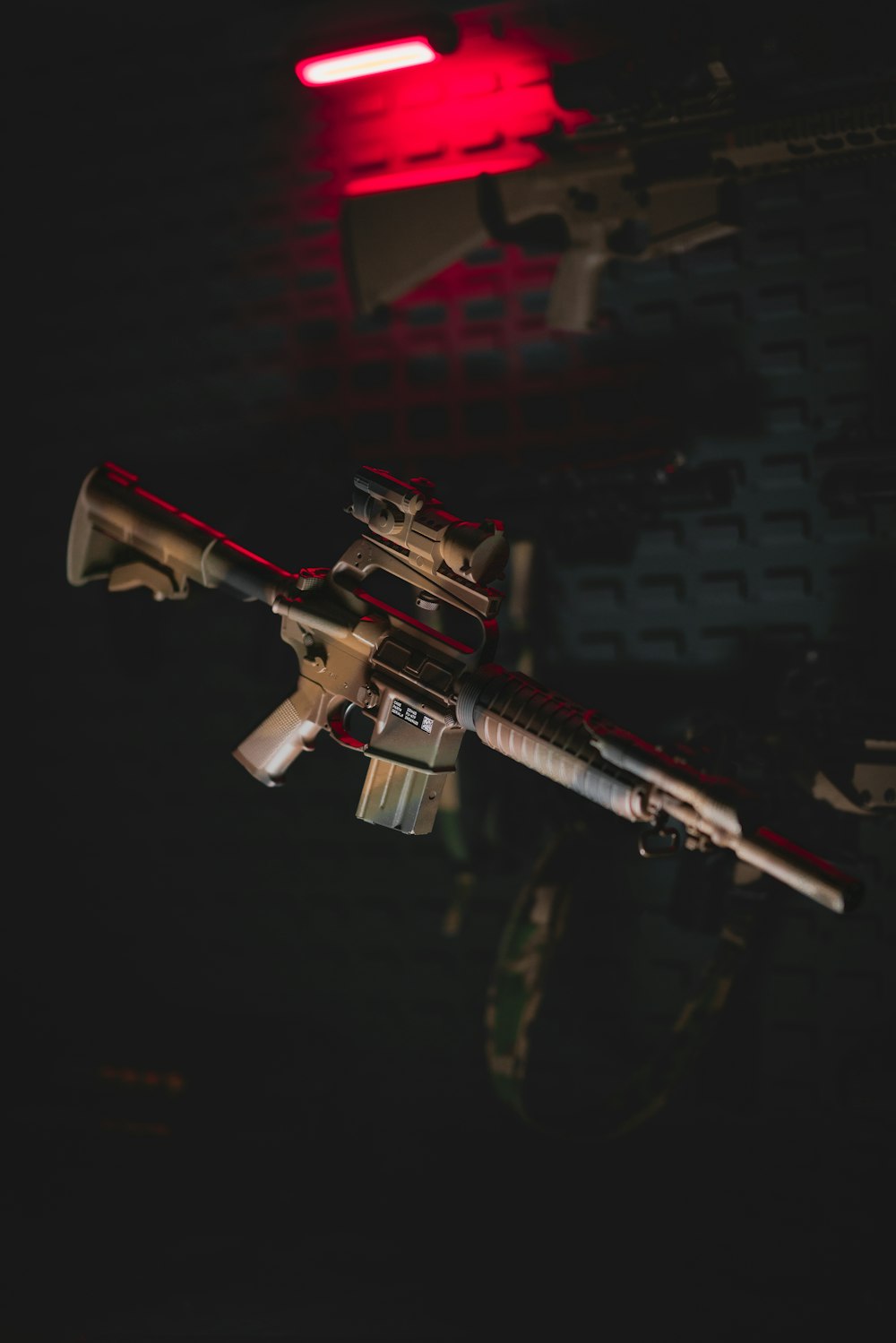 a toy gun hanging from the ceiling in a dark room