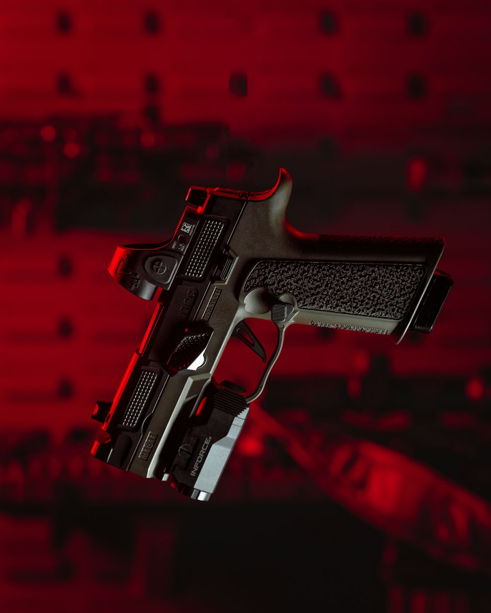 a close up of a gun on a red background