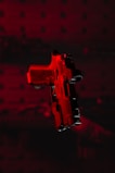 a red gun with a black background