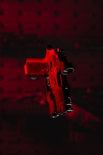 a red gun with a black background