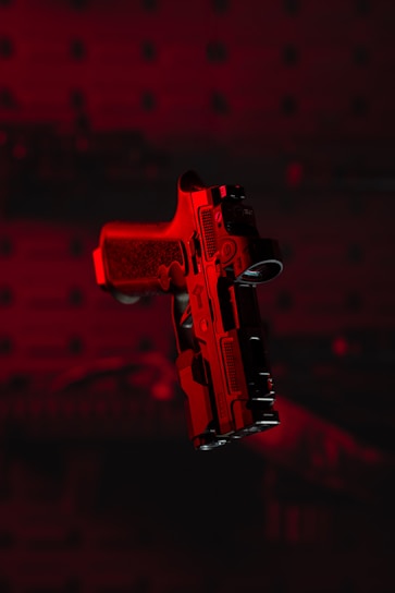 a red gun with a black background