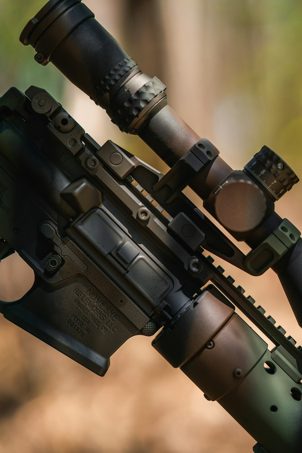 a close up of a rifle with a scope attached to it