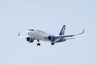 a large jetliner flying through a blue sky