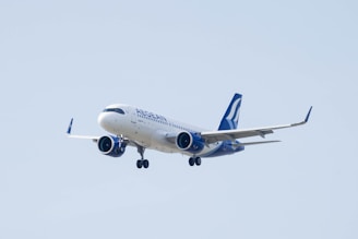 a large jetliner flying through a blue sky