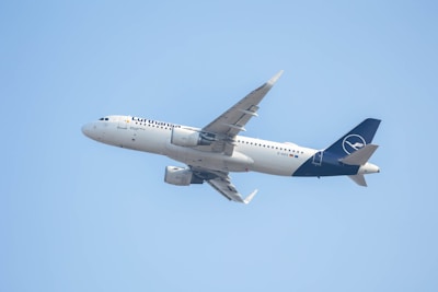 a large jetliner flying through a blue sky