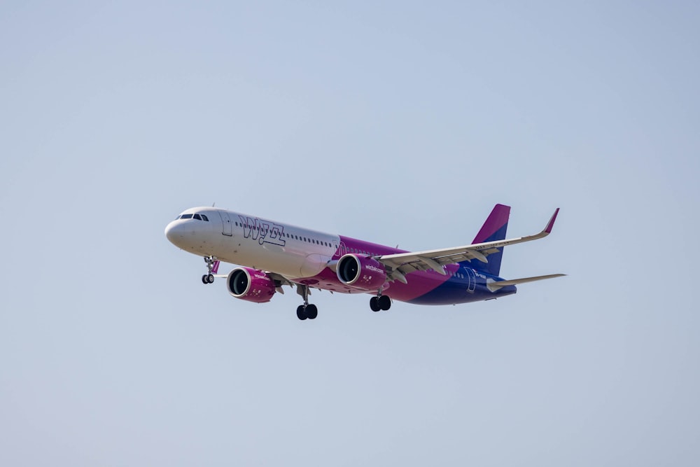 a large jetliner flying through a blue sky