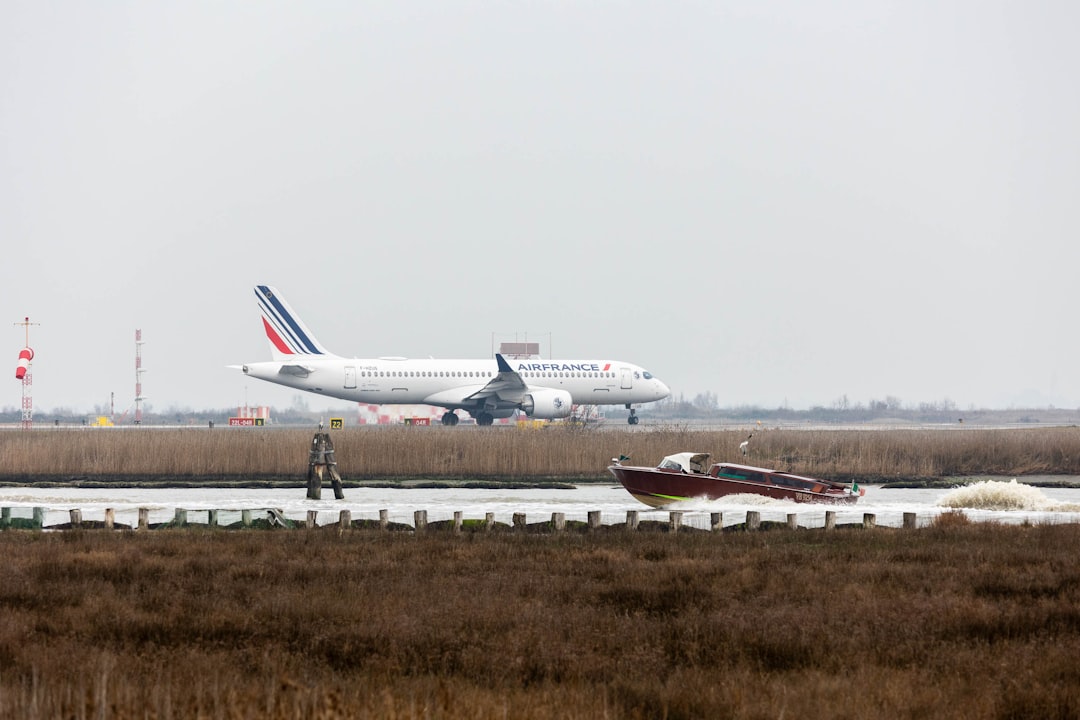 a large jetliner sitting on top of an airport runway, Airline of a French company landing with landing gear extracted.