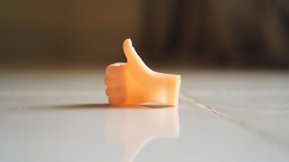 a thumb - shaped object on a white surface