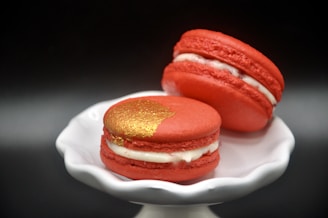 two red and white macaroons on a white plate