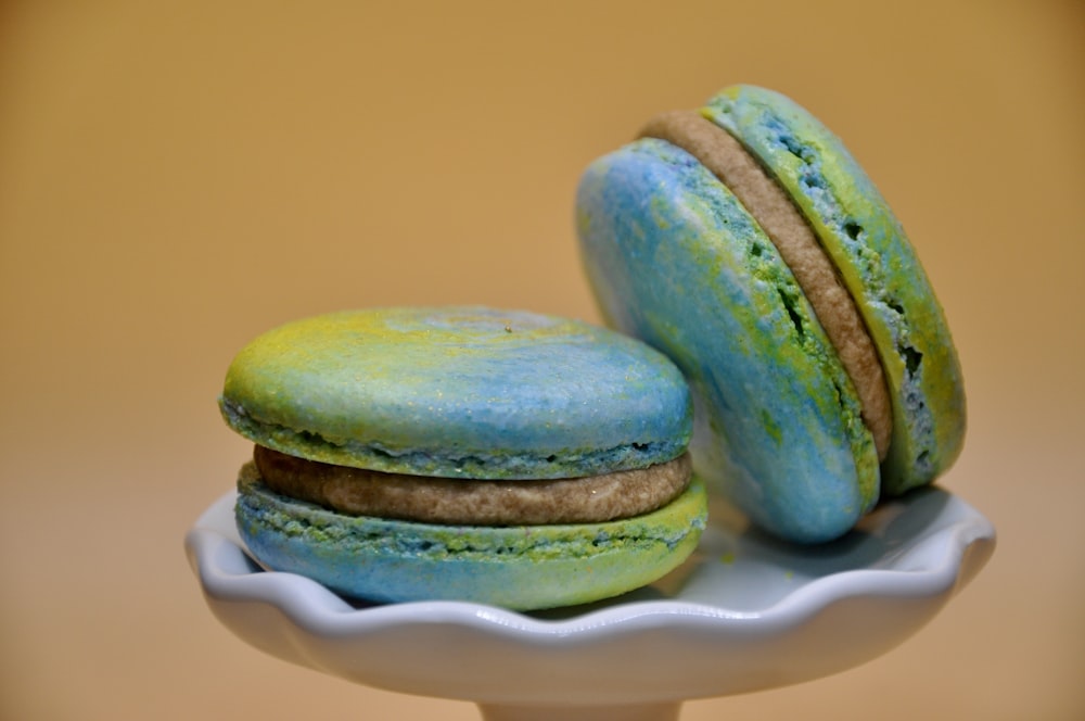 a couple of macaroons sitting on top of a white plate