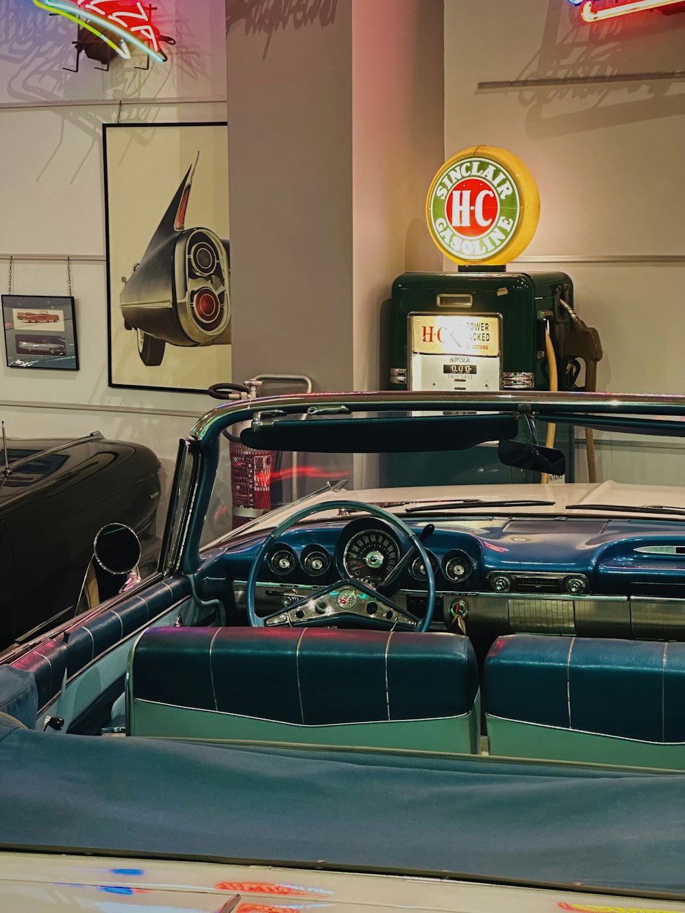 the interior of a car showroom with a vintage car