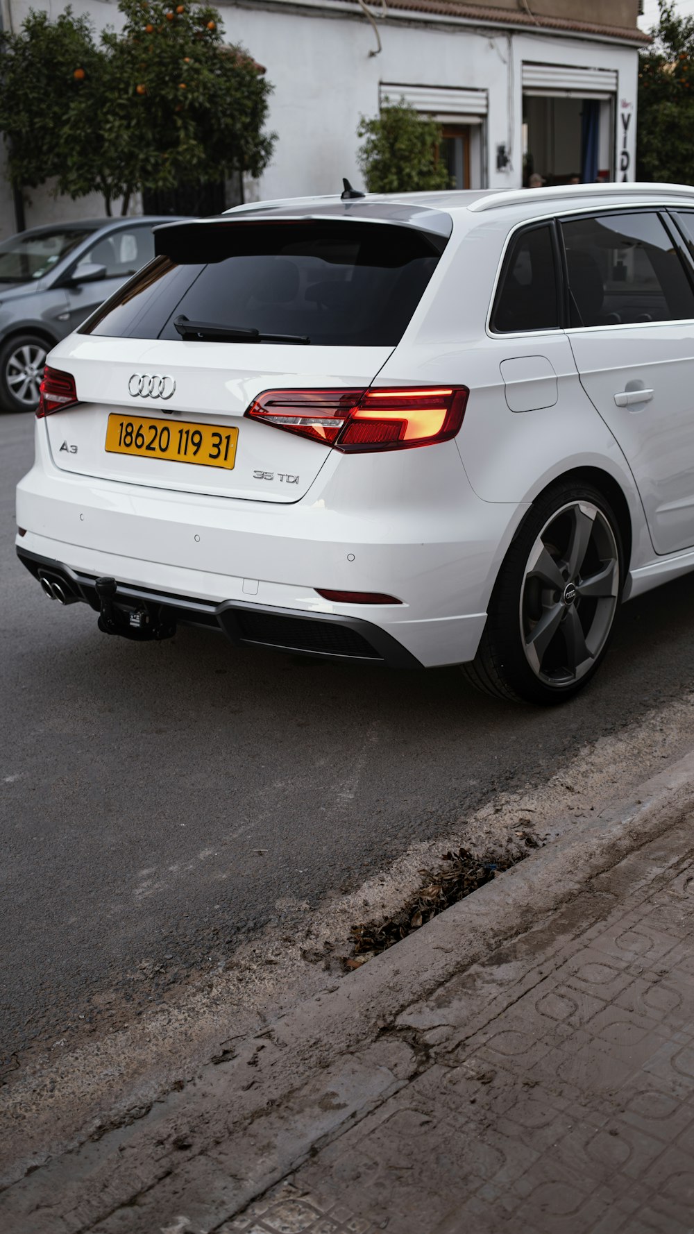 a white car parked on the side of the road