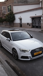 a white car parked on the side of the road