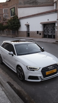 a white car parked on the side of the road