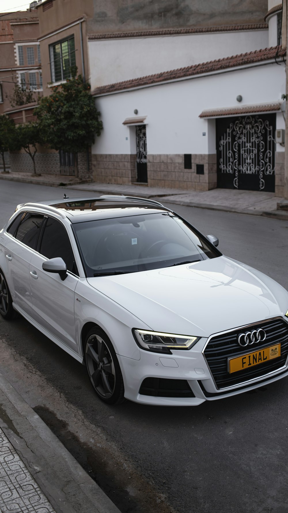 a white car parked on the side of the road