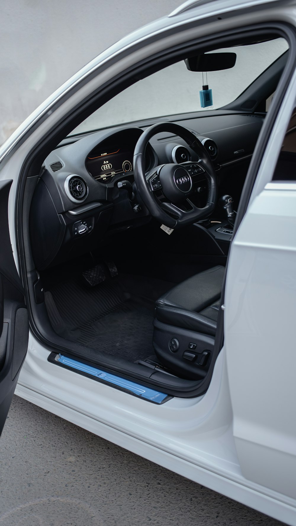 the interior of a car with its door open