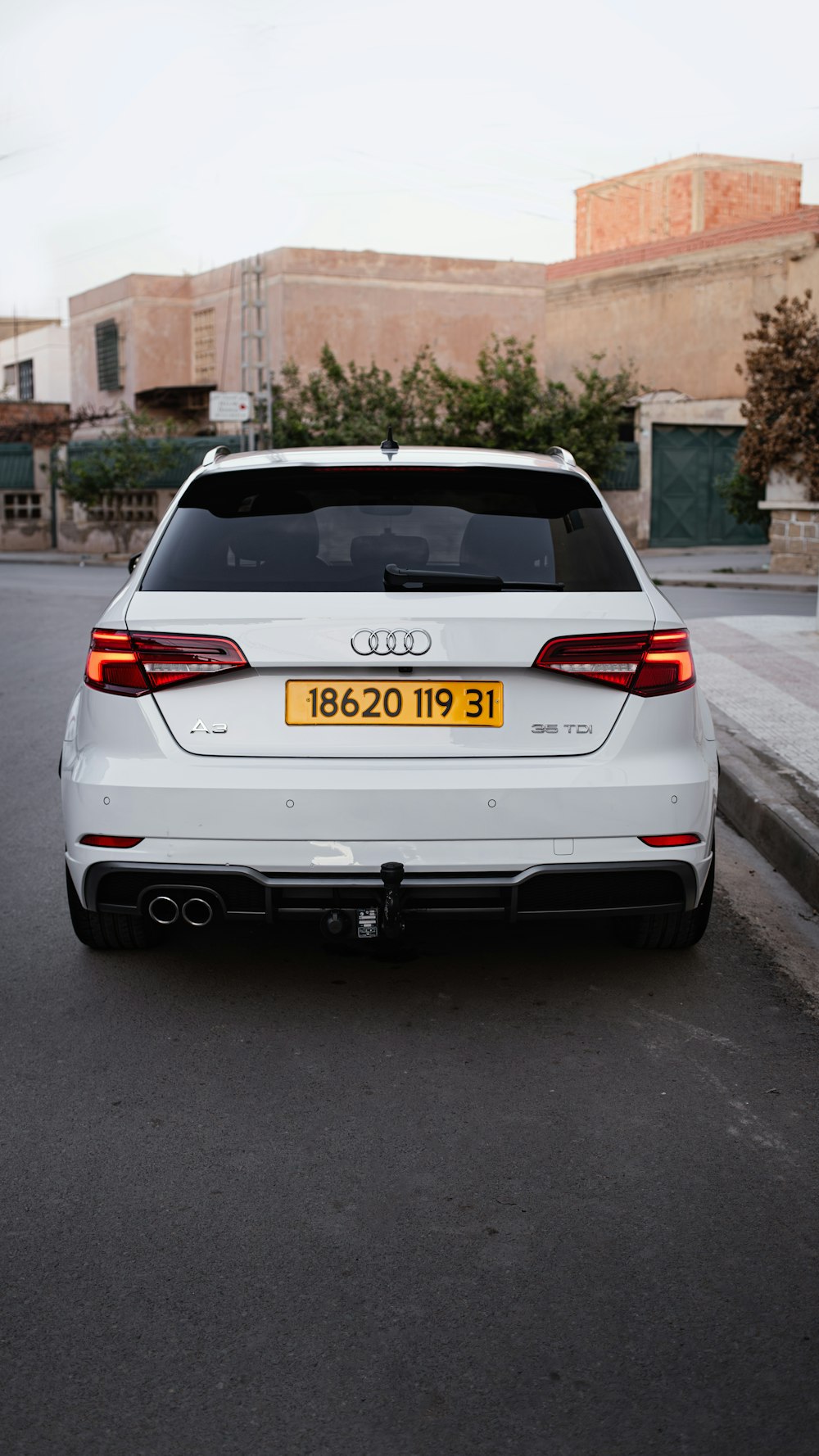 a white car parked on the side of the road