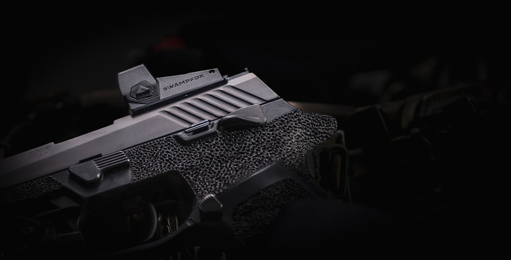 a close up of a gun in the dark