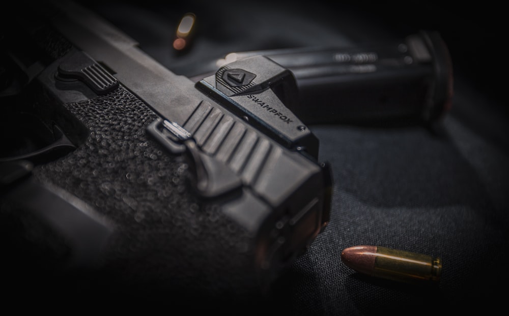 a close up of a gun and a bullet