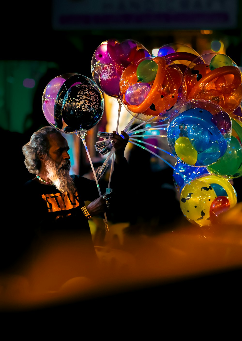 a woman holding a bunch of balloons in her hand