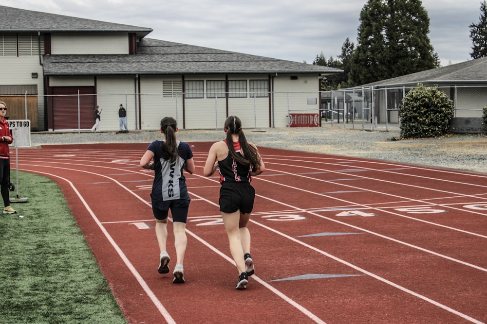 a group of girls running on a track