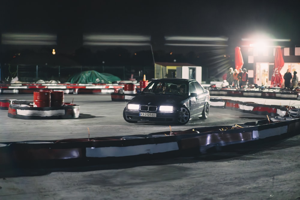 a car is driving around a track at night