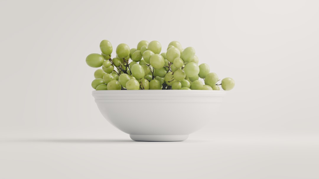 A bowl of grapes set in a studio lighting setup.