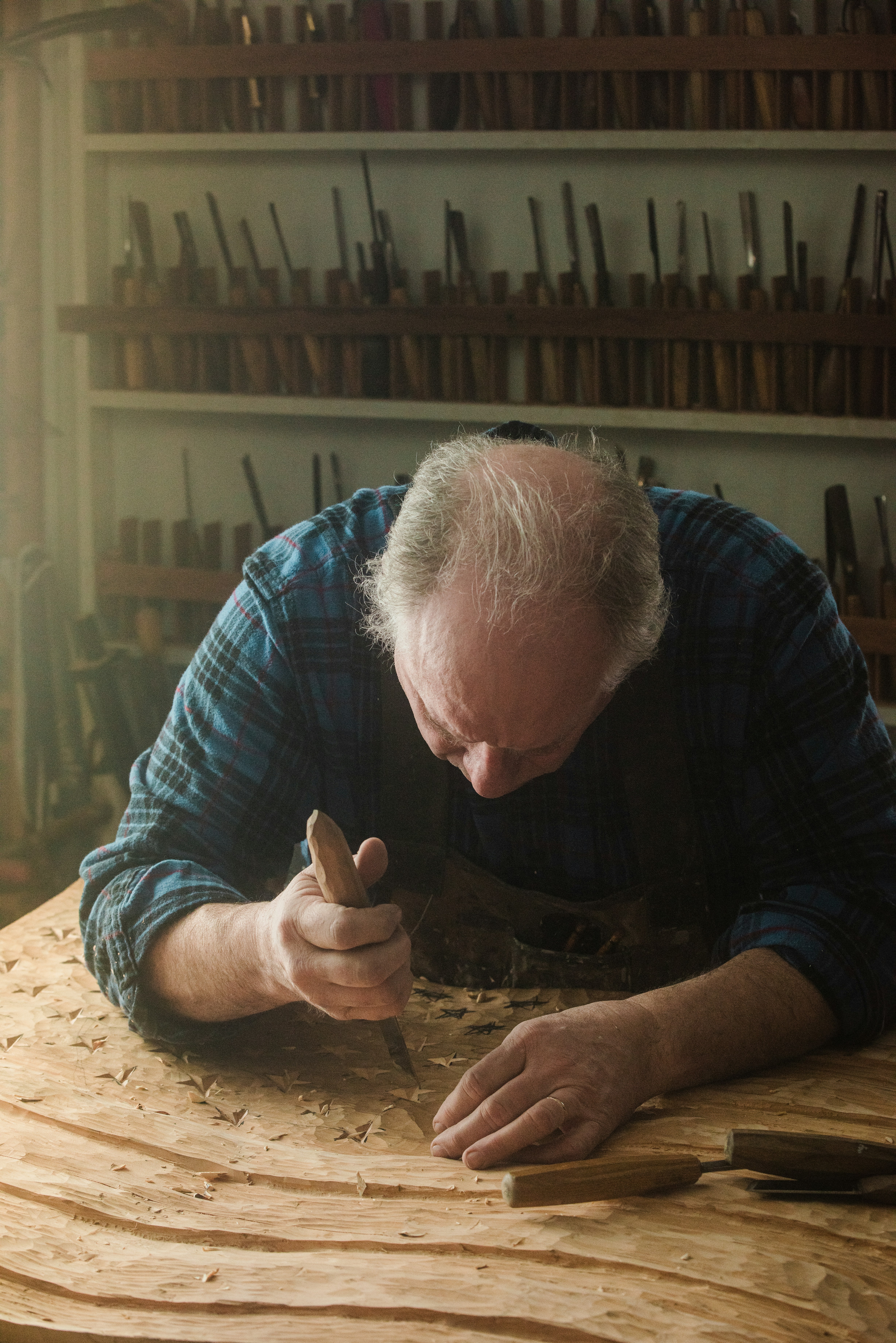 a man working on a piece of wood