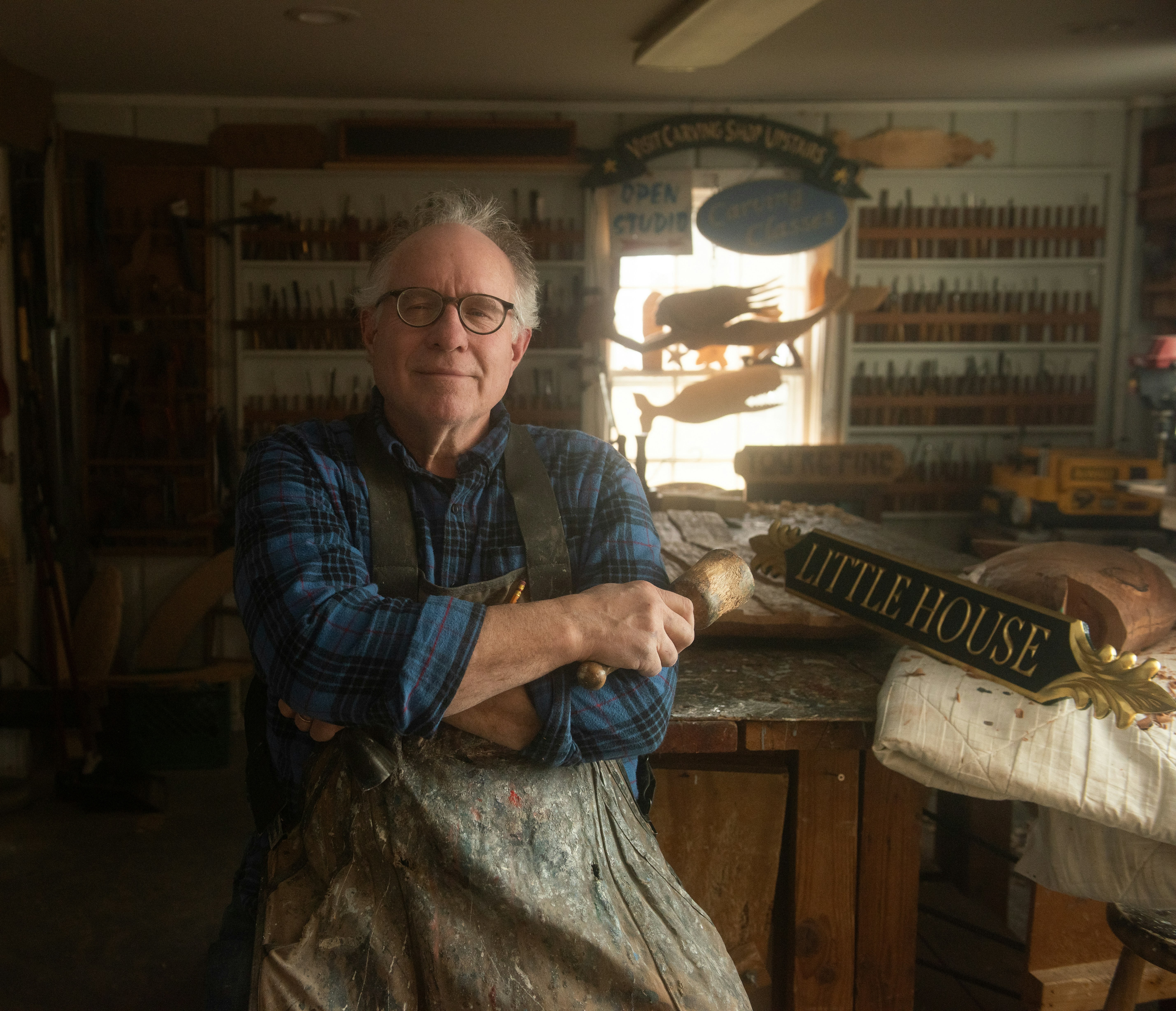 a man in an old fashioned shop with his arms crossed