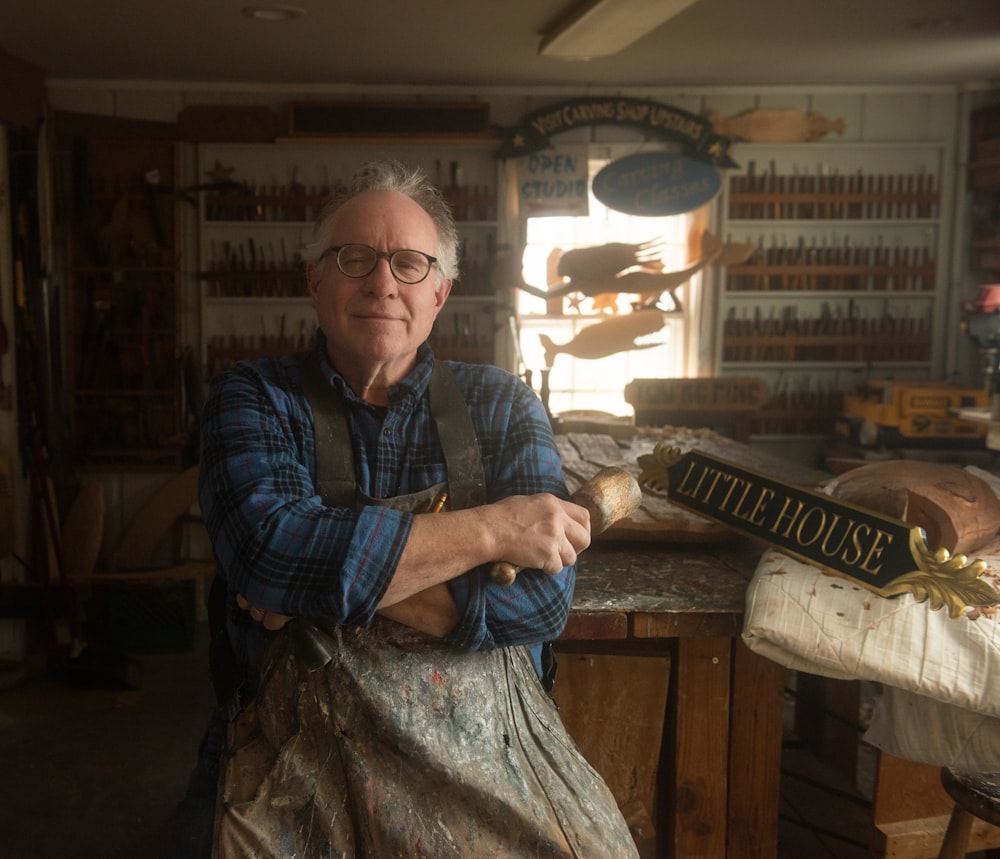 a man in an old fashioned shop with his arms crossed