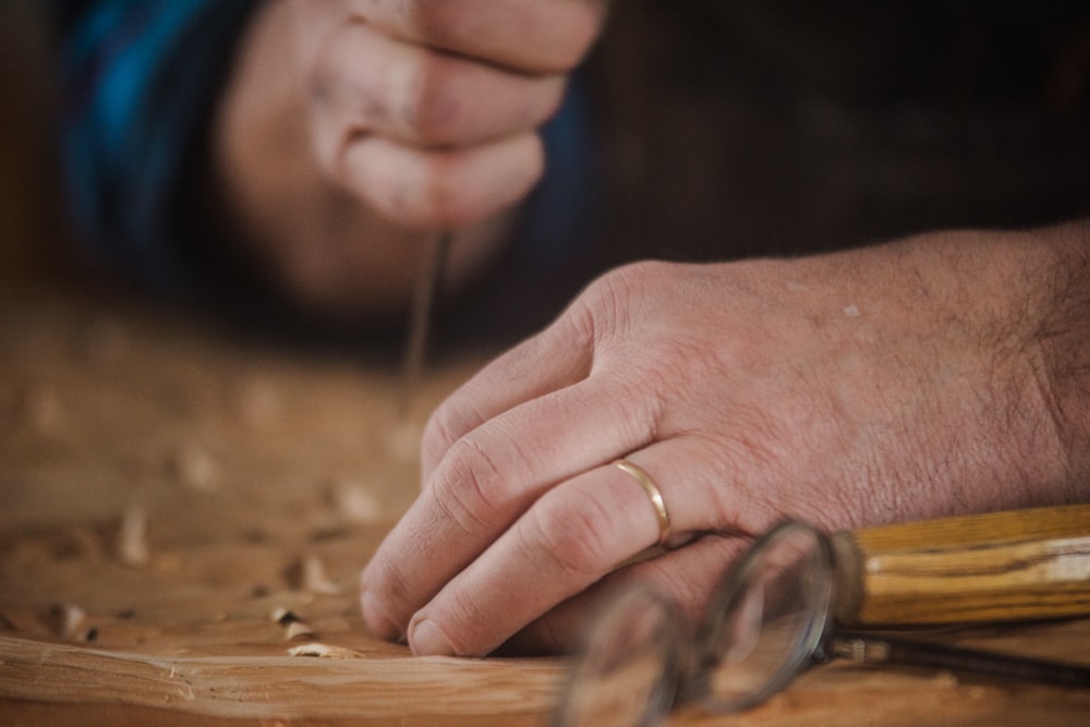 a close up of a person working with wood