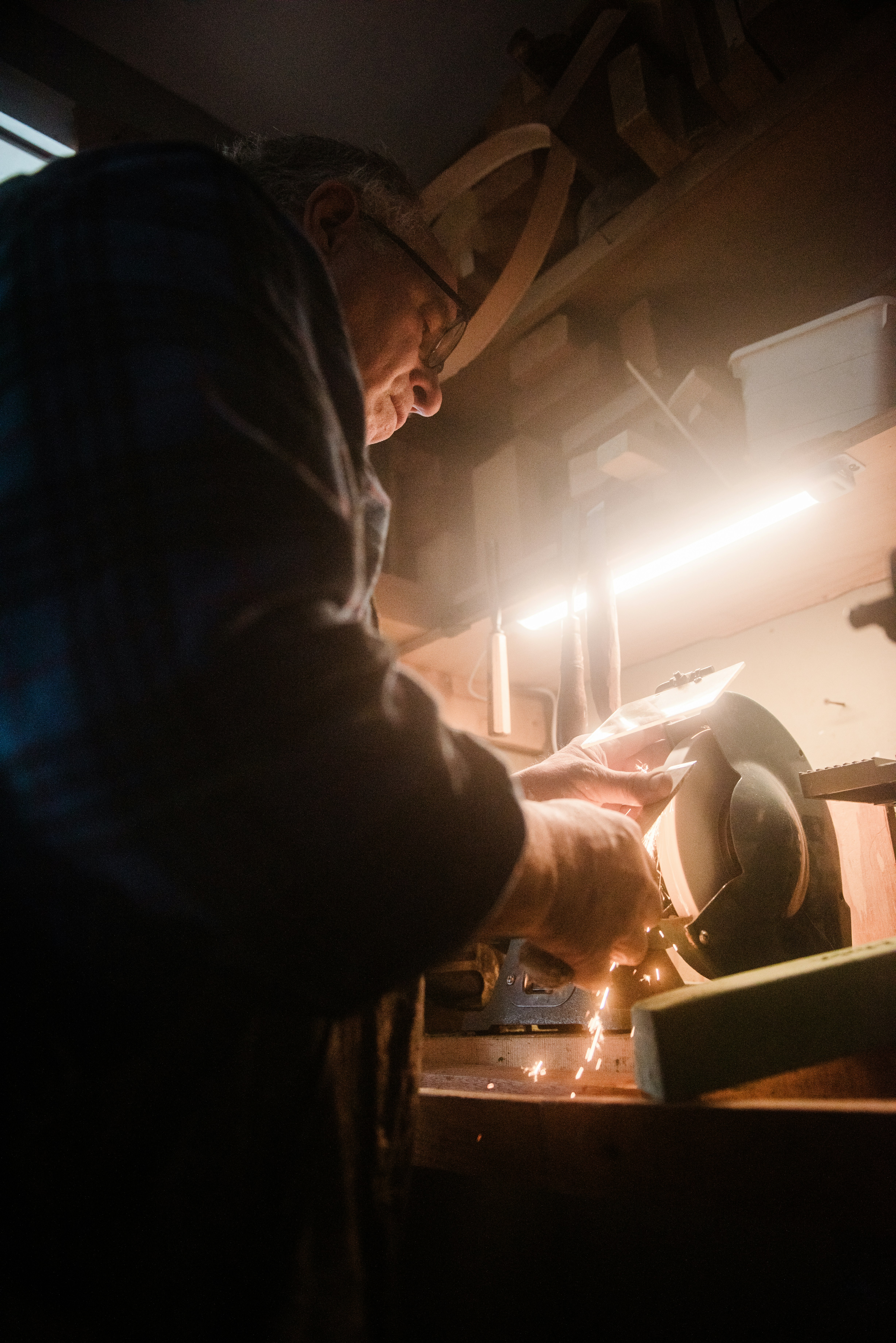 a man working with a grinder on a table