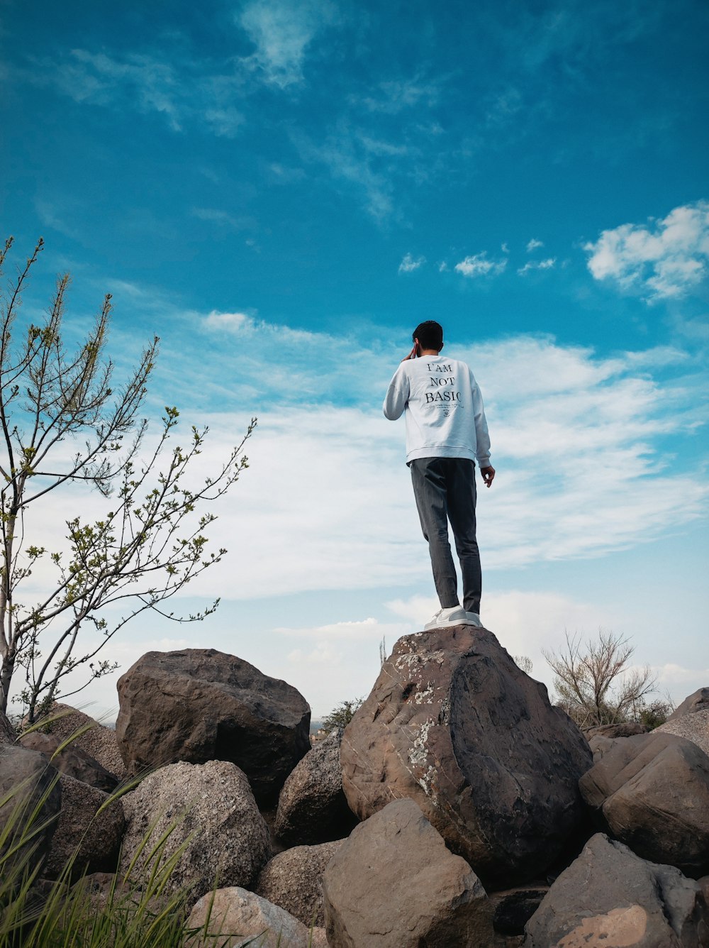 a man standing on top of a pile of rocks