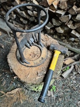 a hammer and a log on the ground