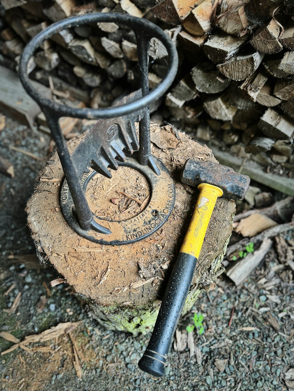 a hammer and a log on the ground