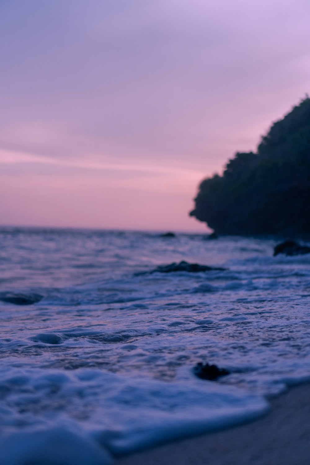 a beach with waves coming in to the shore