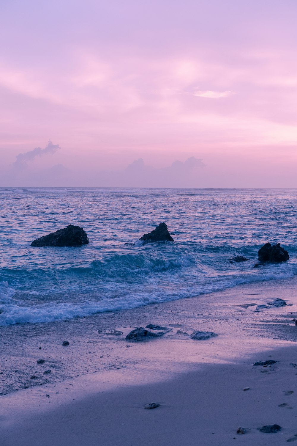 a beach that has some rocks in the water