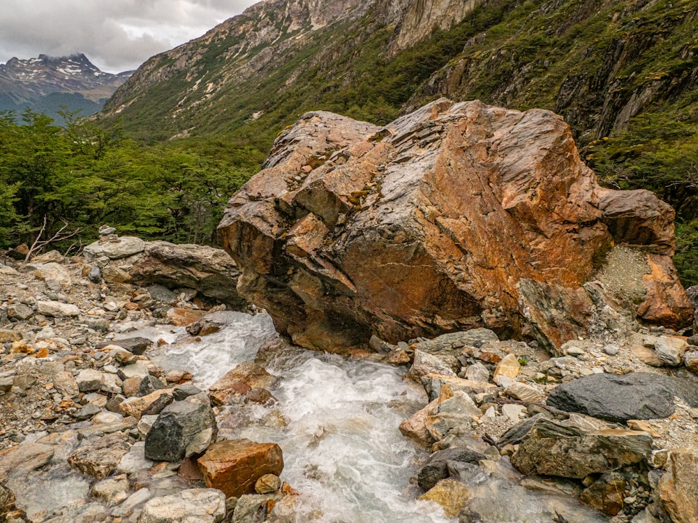 a large rock sitting on top of a rocky river