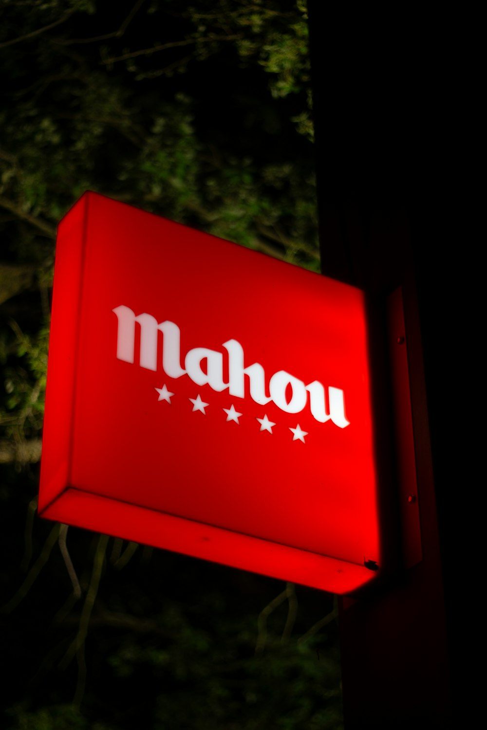 a red sign that says mahou on it