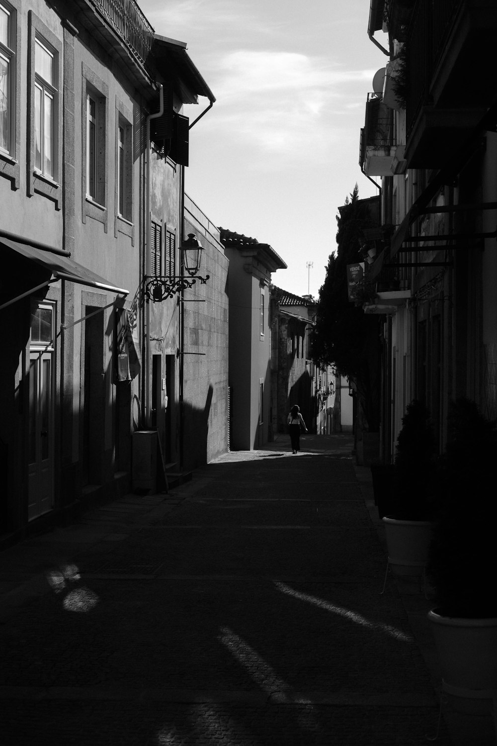 a black and white photo of a narrow street