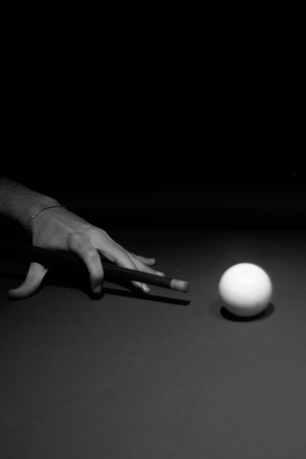 a person reaching for a ball on a table