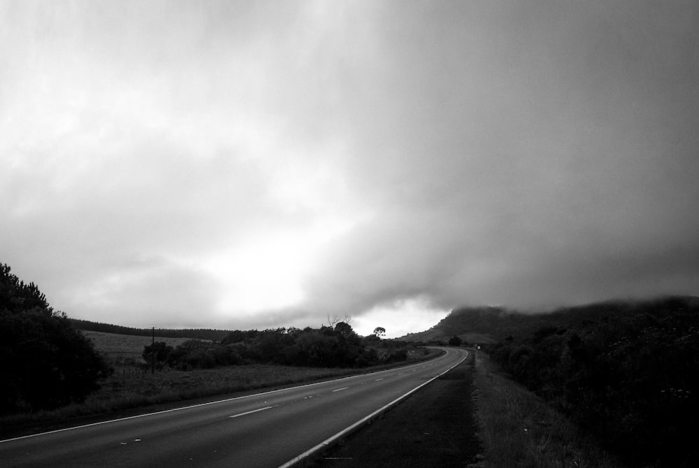 a black and white photo of a highway