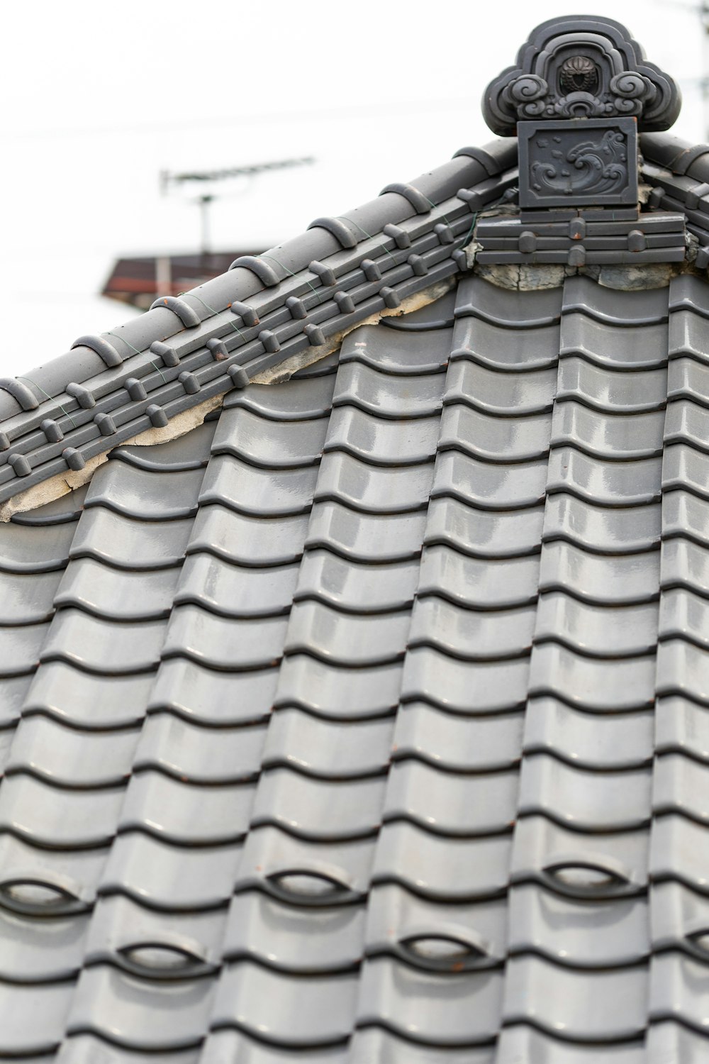 a close up of a roof with a clock on it