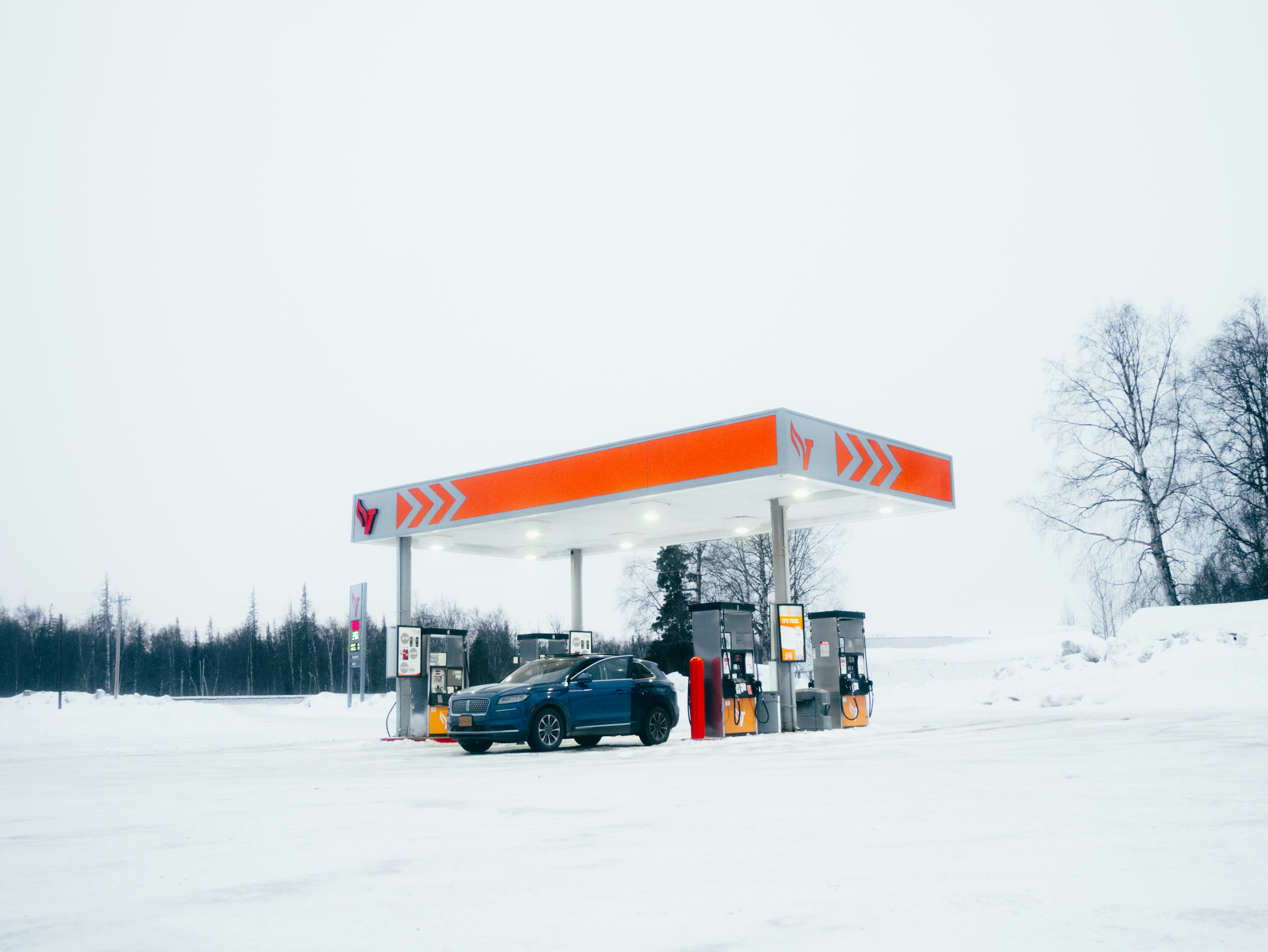 Car at gas station in snow