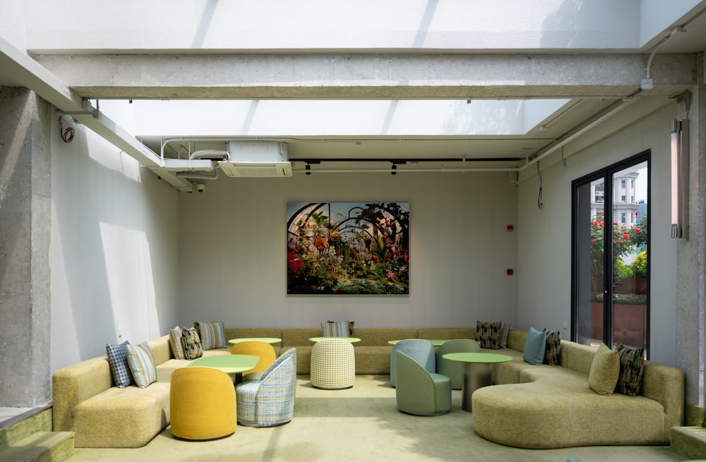 a living room filled with furniture and a painting on the wall