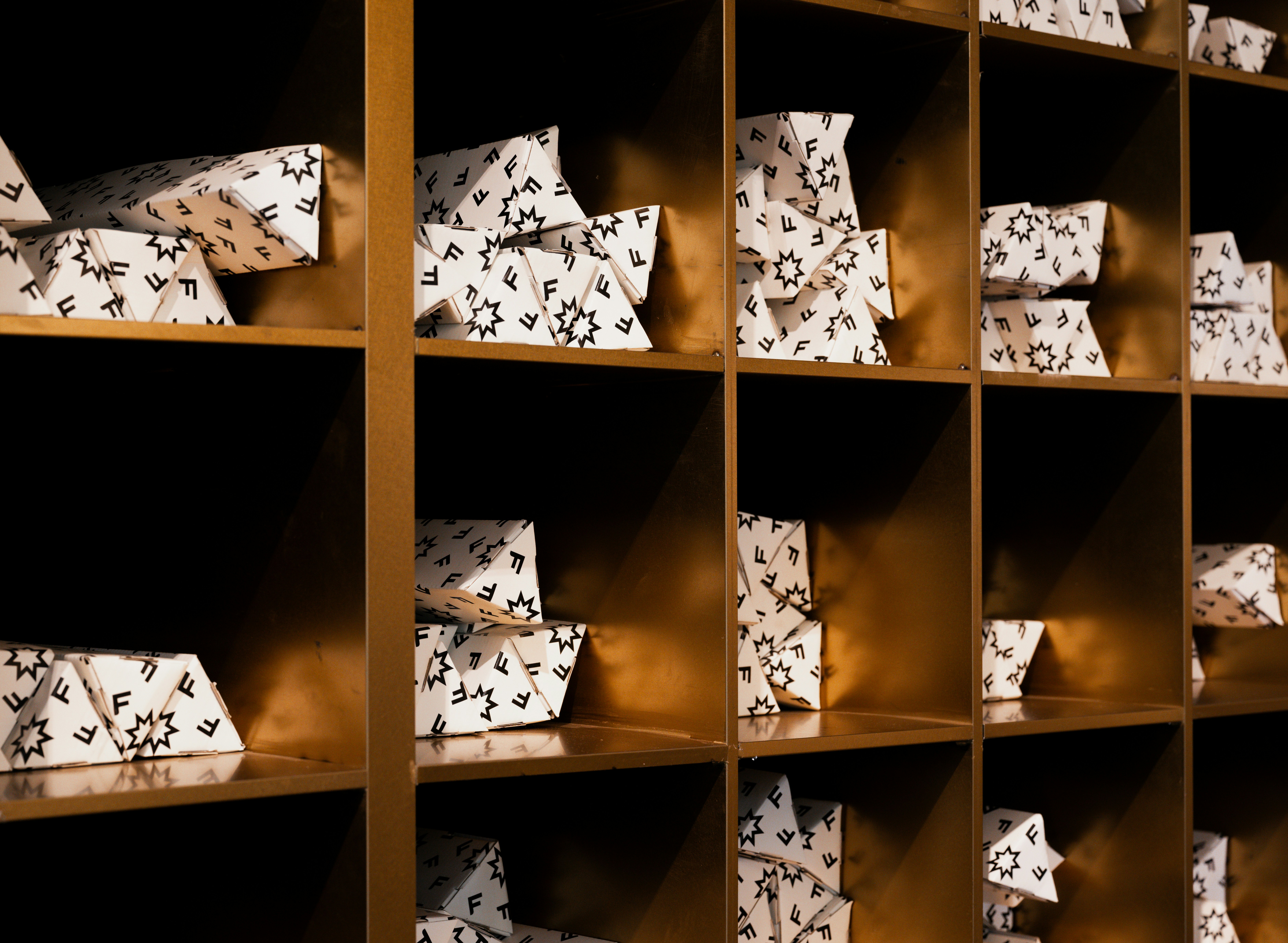Some triangular prism-looking objects on the shelf