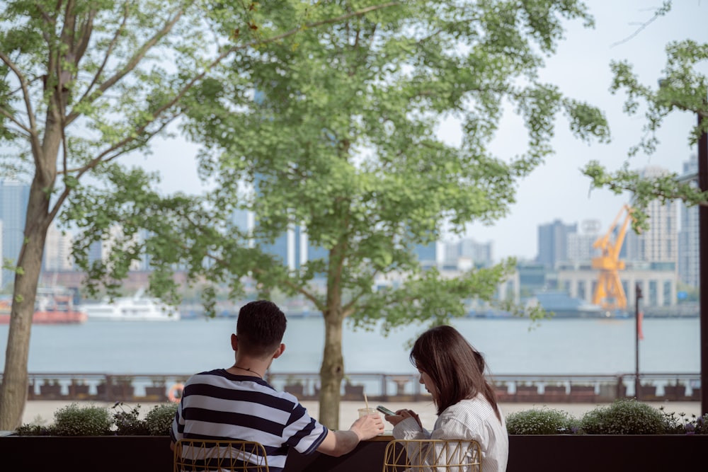 a man and a woman sitting on a bench