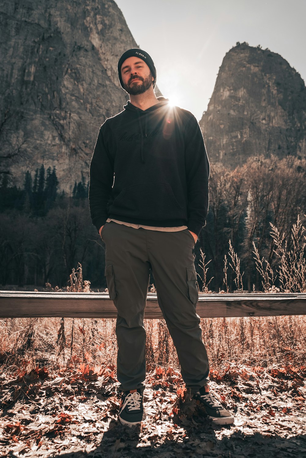 a man standing in front of a mountain