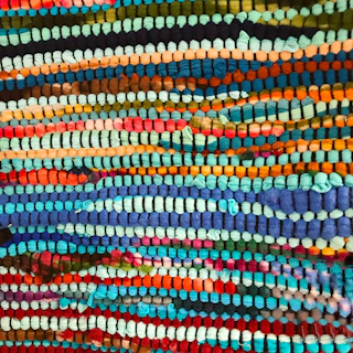 a close up of a multicolored wall hanging