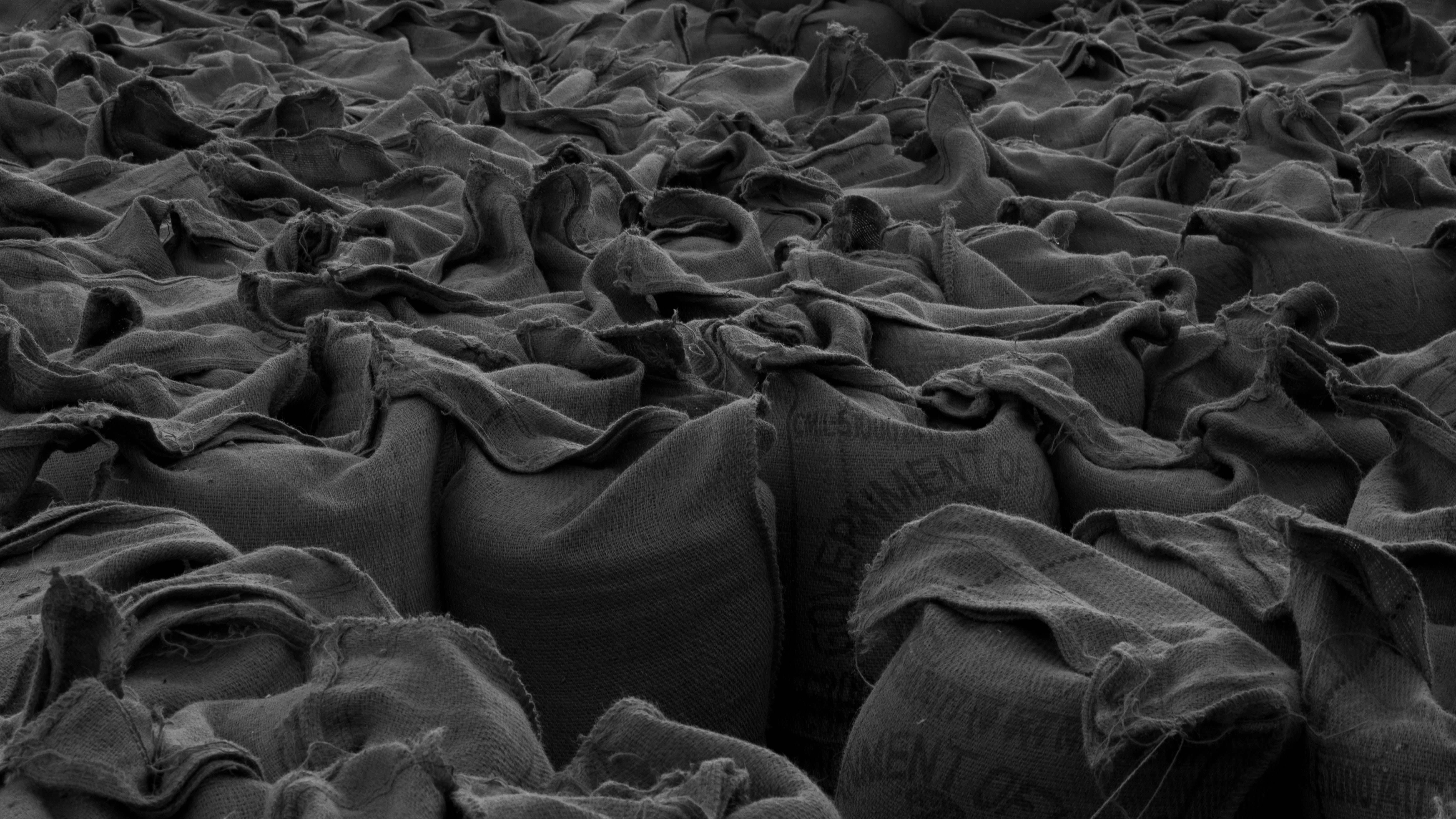 a black and white photo of bags of sand